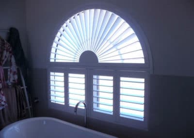 arched window shutters in bathroom