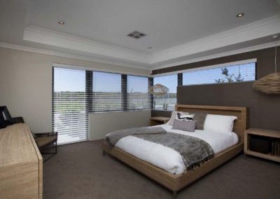 bedroom with large windows and venetian blinds