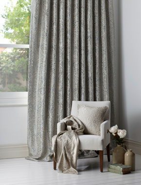 grey patterned curtains with chair