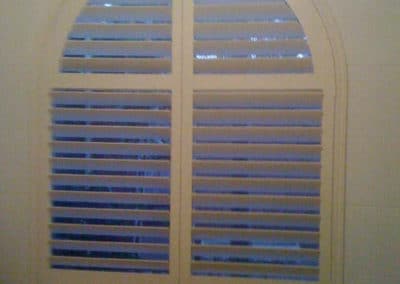 shutters over arched window