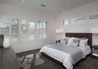white bedroom with shutters